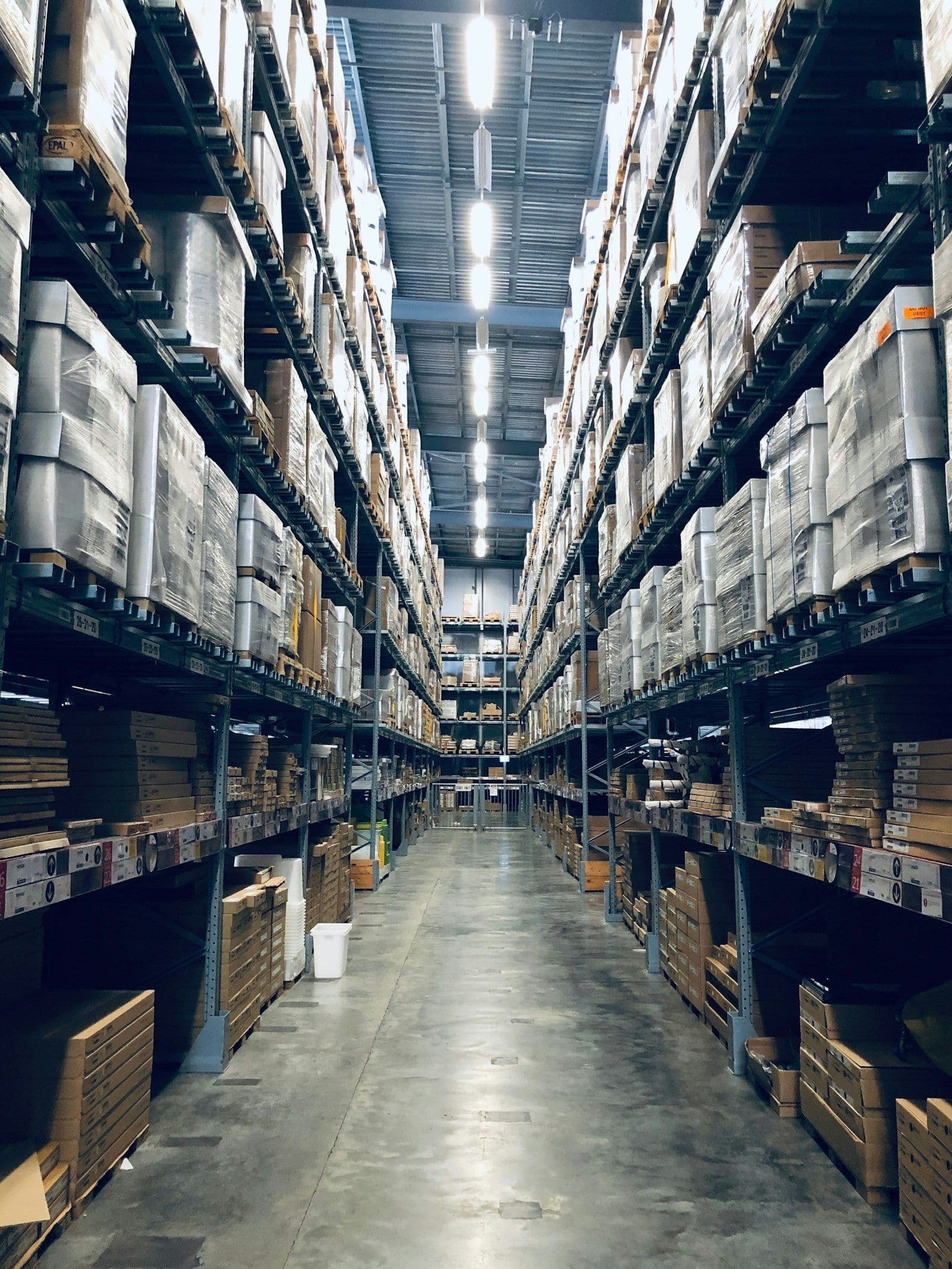 Warehouse aisle stocked with boxed hardware and building supplies